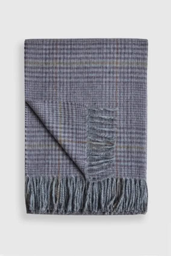 Folded Tartan Alpaca Wool Throw Blanket in blue plaid with fringe, showcasing soft and durable texture for home bedding use.