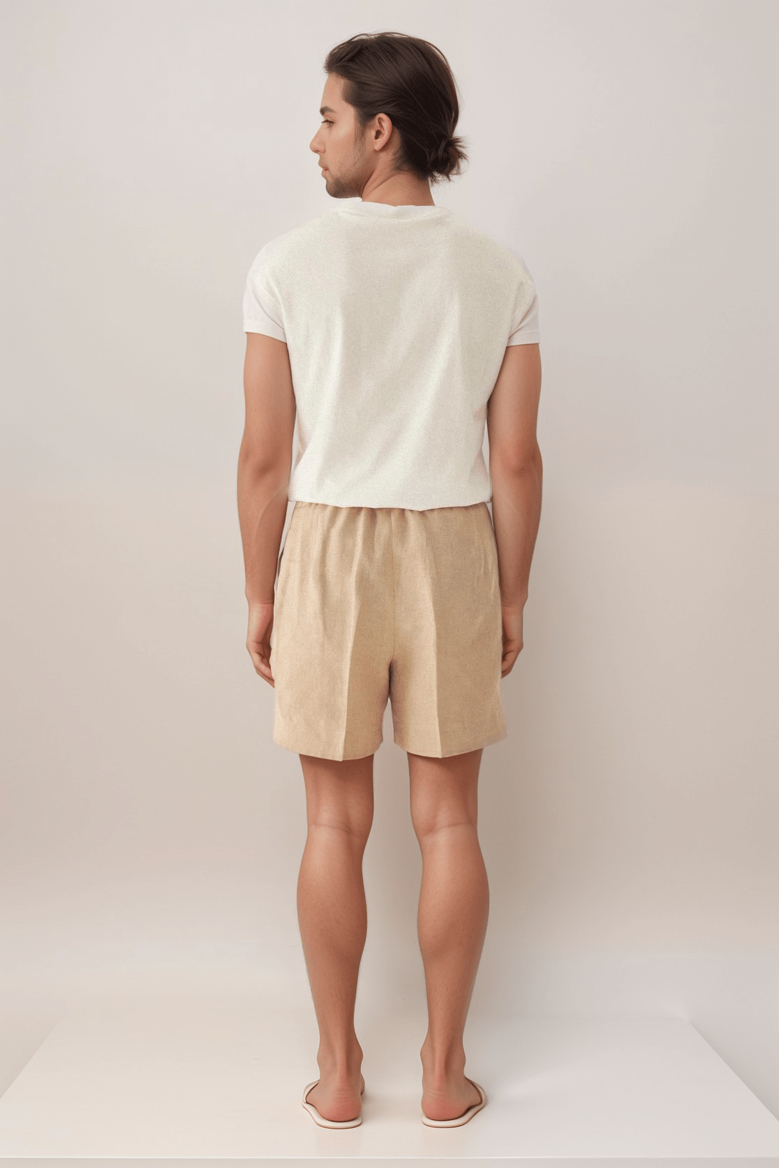 Back view of men's beige linen shorts featuring an elastic waistband and clean hem, ideal for stylish and comfortable daily wear.