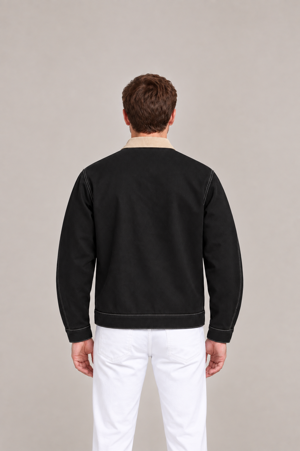 Black cotton contrast-collar jacket on a model, back with a plain panel and stitched hem.