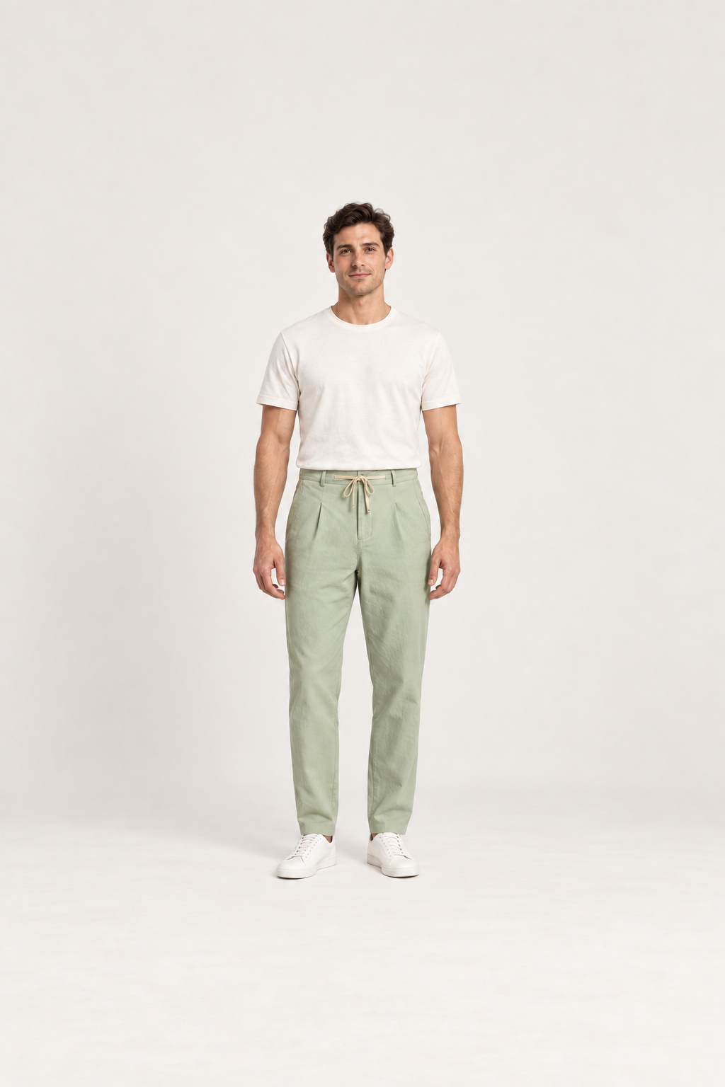Green cotton pleated drawstring pants, front view on an adult model.