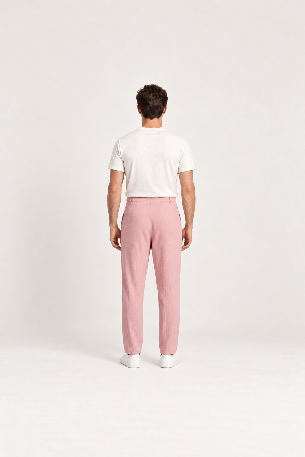 Pink cotton pleated drawstring pants, back view on an adult model.
