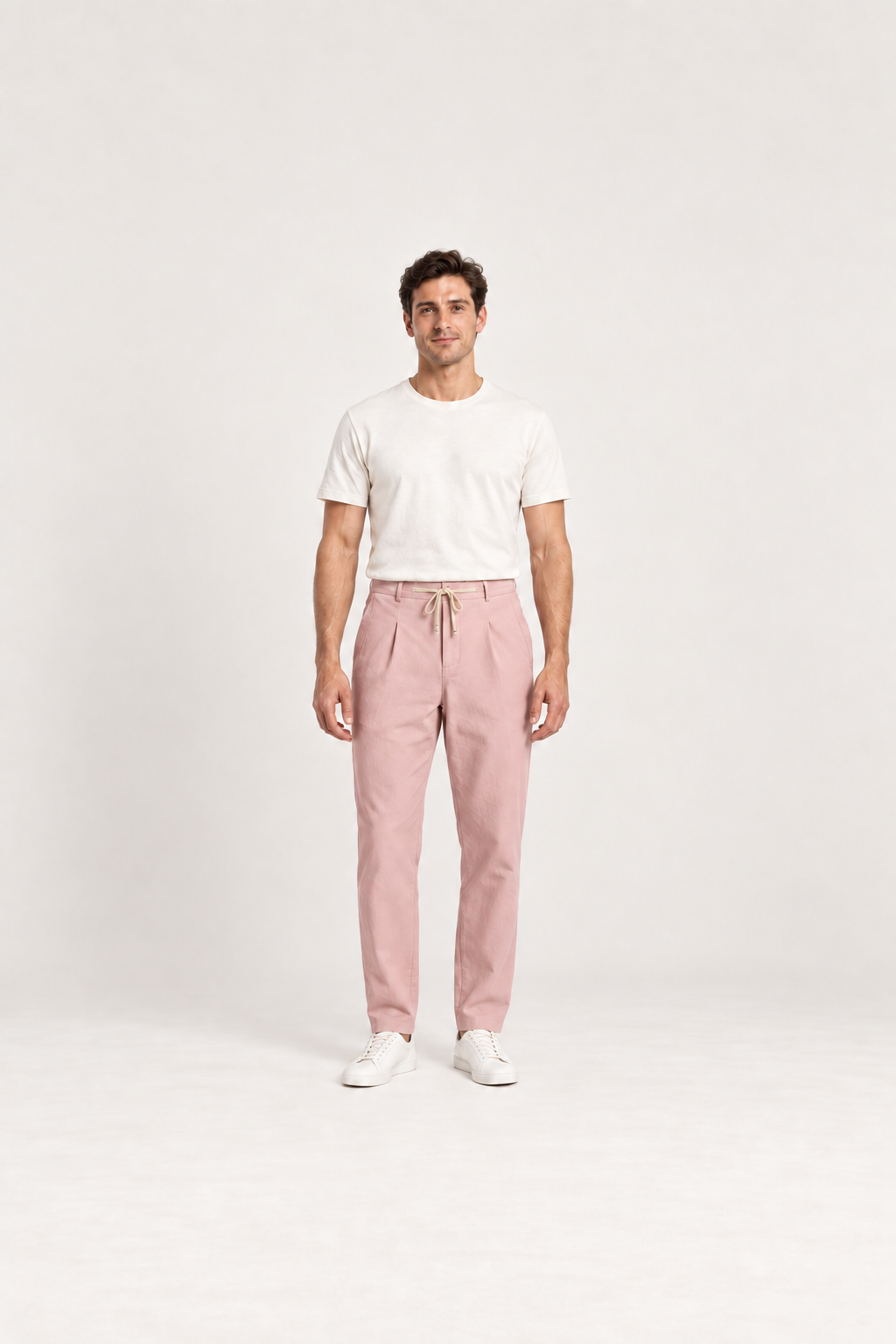 Pink cotton pleated drawstring pants, front view on an adult model.