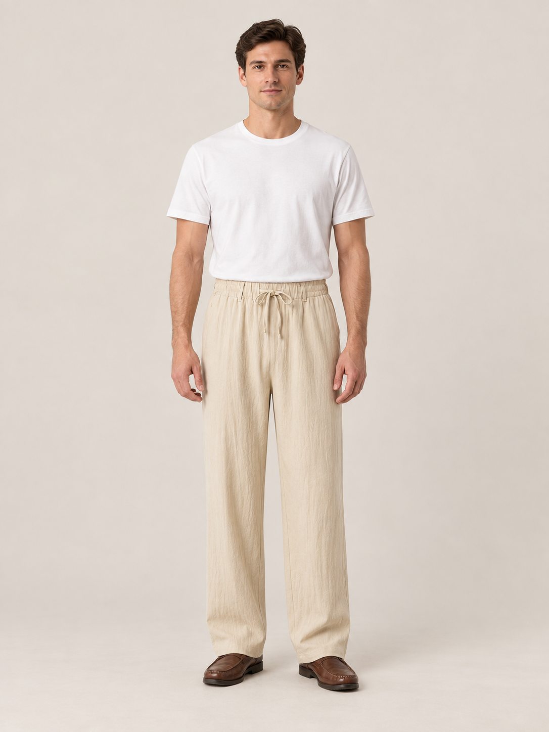 Khaki woven drawstring trousers, front view on a model.