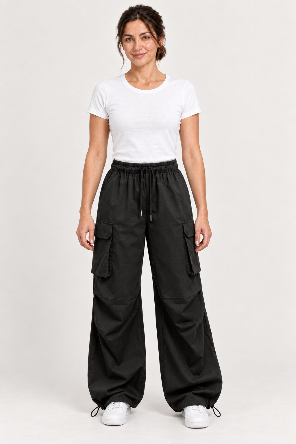 Black cotton drawstring cargo pants, front view on an adult model.