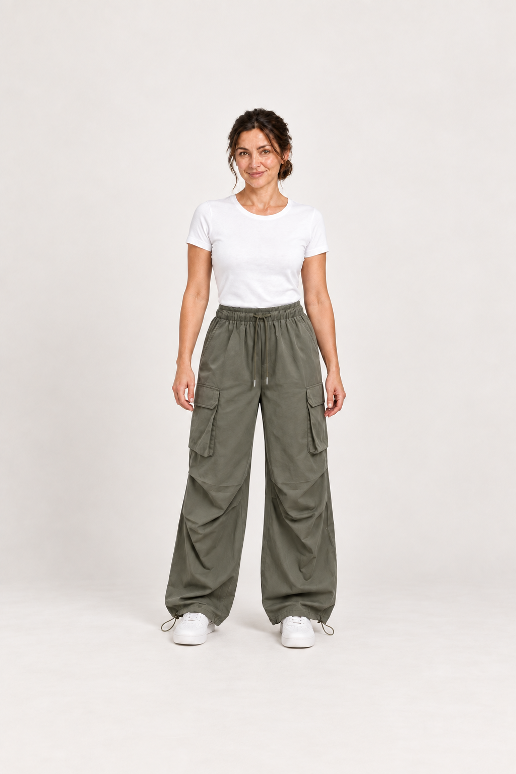 Green cotton cargo pants, model front.
