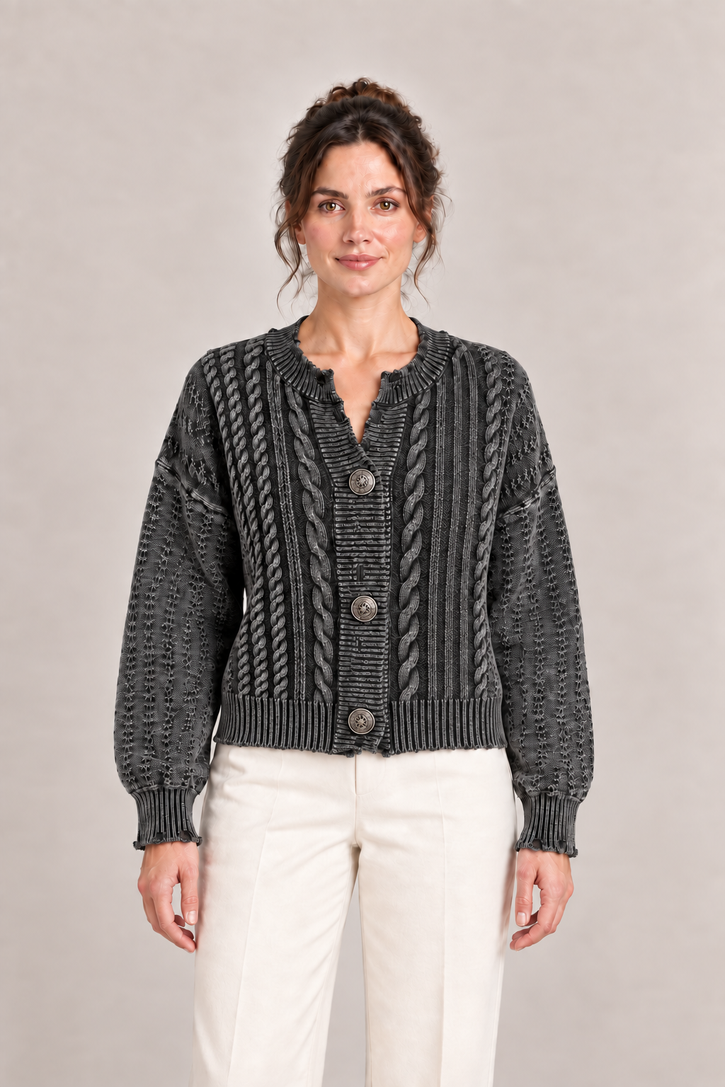 Front view of a charcoal-grey cable-knit cardigan with three decorative buttons and dropped shoulders.