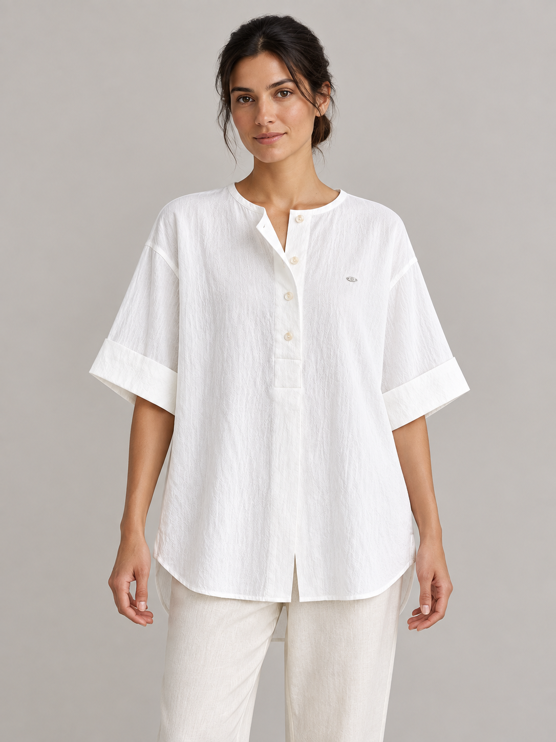White cotton Henley popover with back pleat, model front.