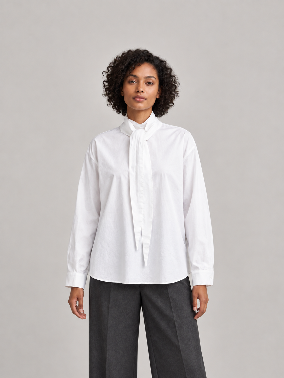 White cotton tie-neck blouse, model front.