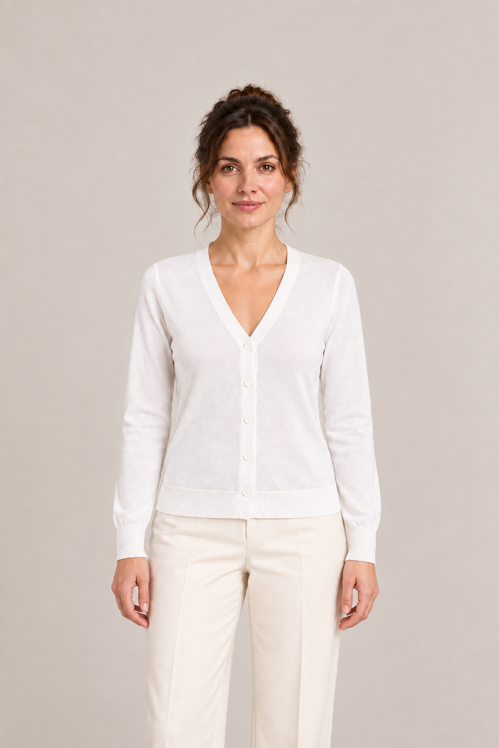 White regular cotton V-neck cardigan on a model, front view.