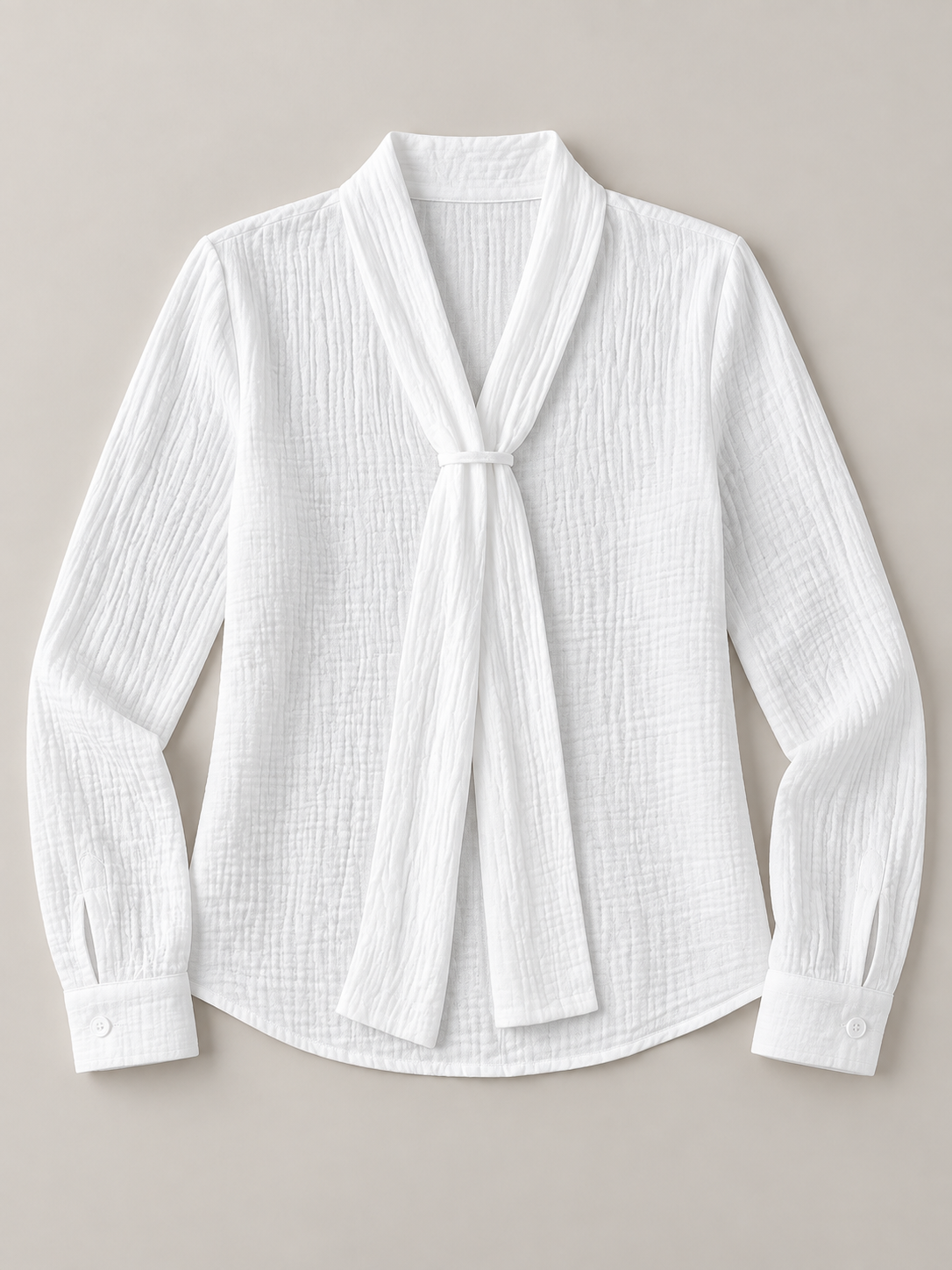White crinkled cotton blouse with scarf neck ties, flat lay front.