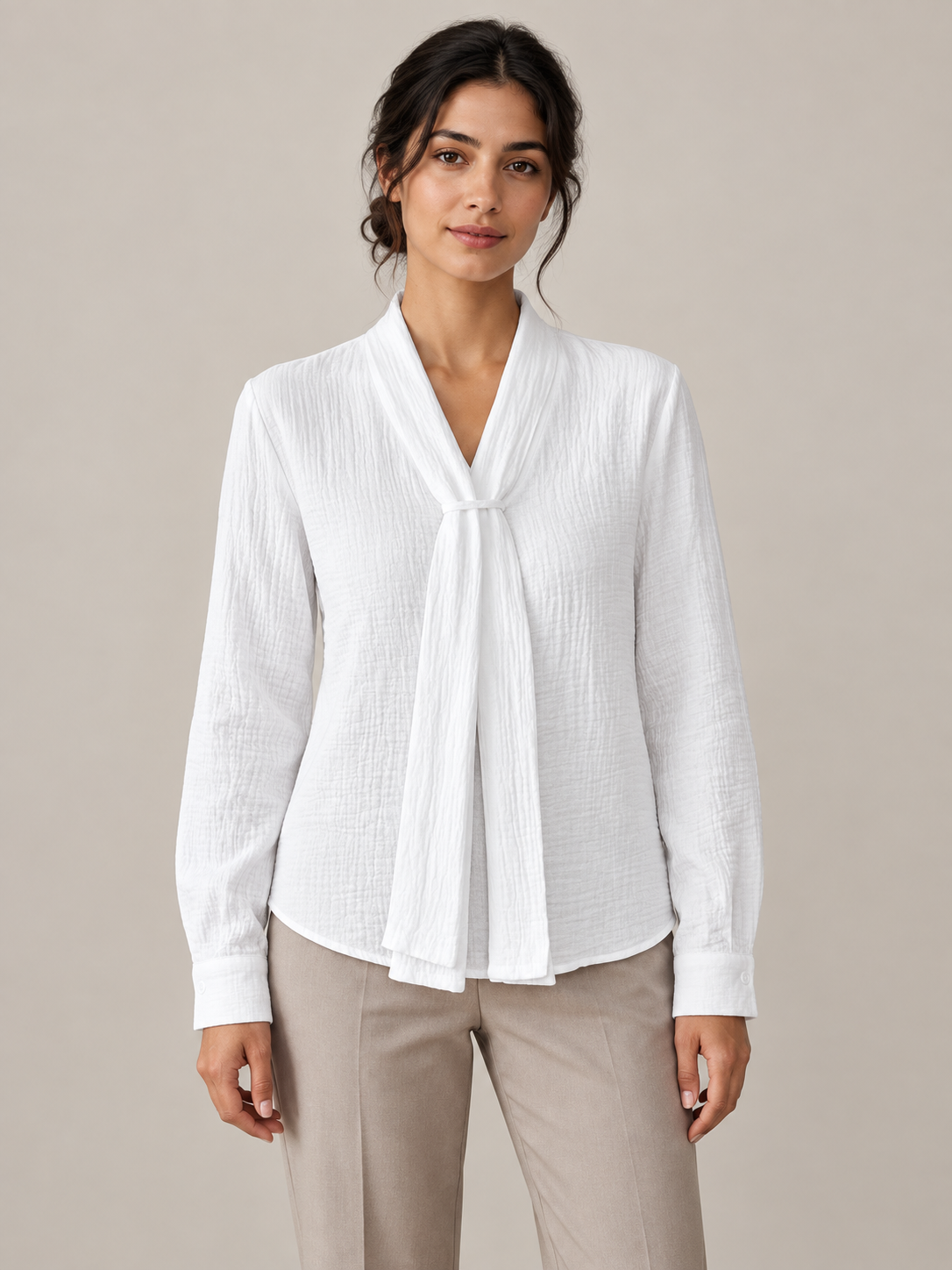 White crinkled cotton blouse with scarf neck ties, model front.