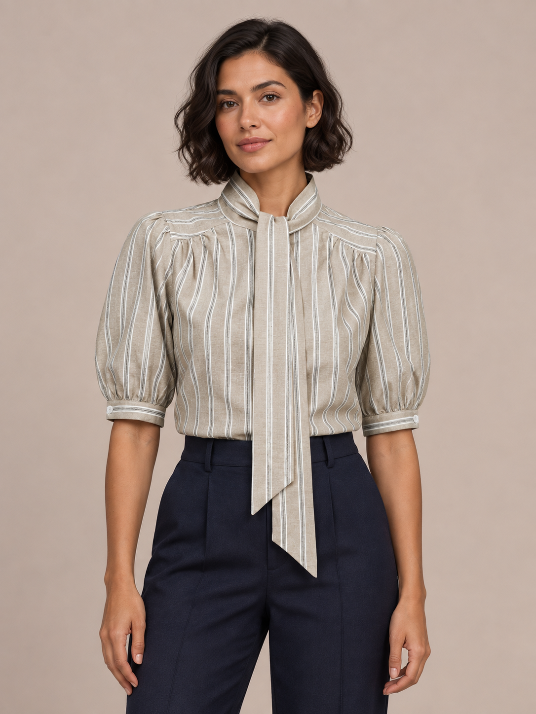 Khaki striped tie-neck puff-sleeve blouse, front styling view tucked into trousers.