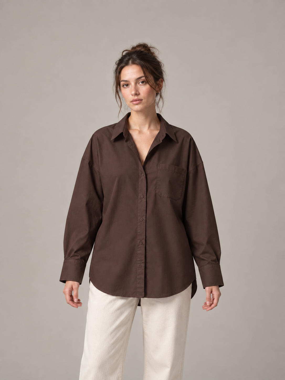 Chocolate brown oversized button-up shirt, front on an original model with a chest patch pocket.