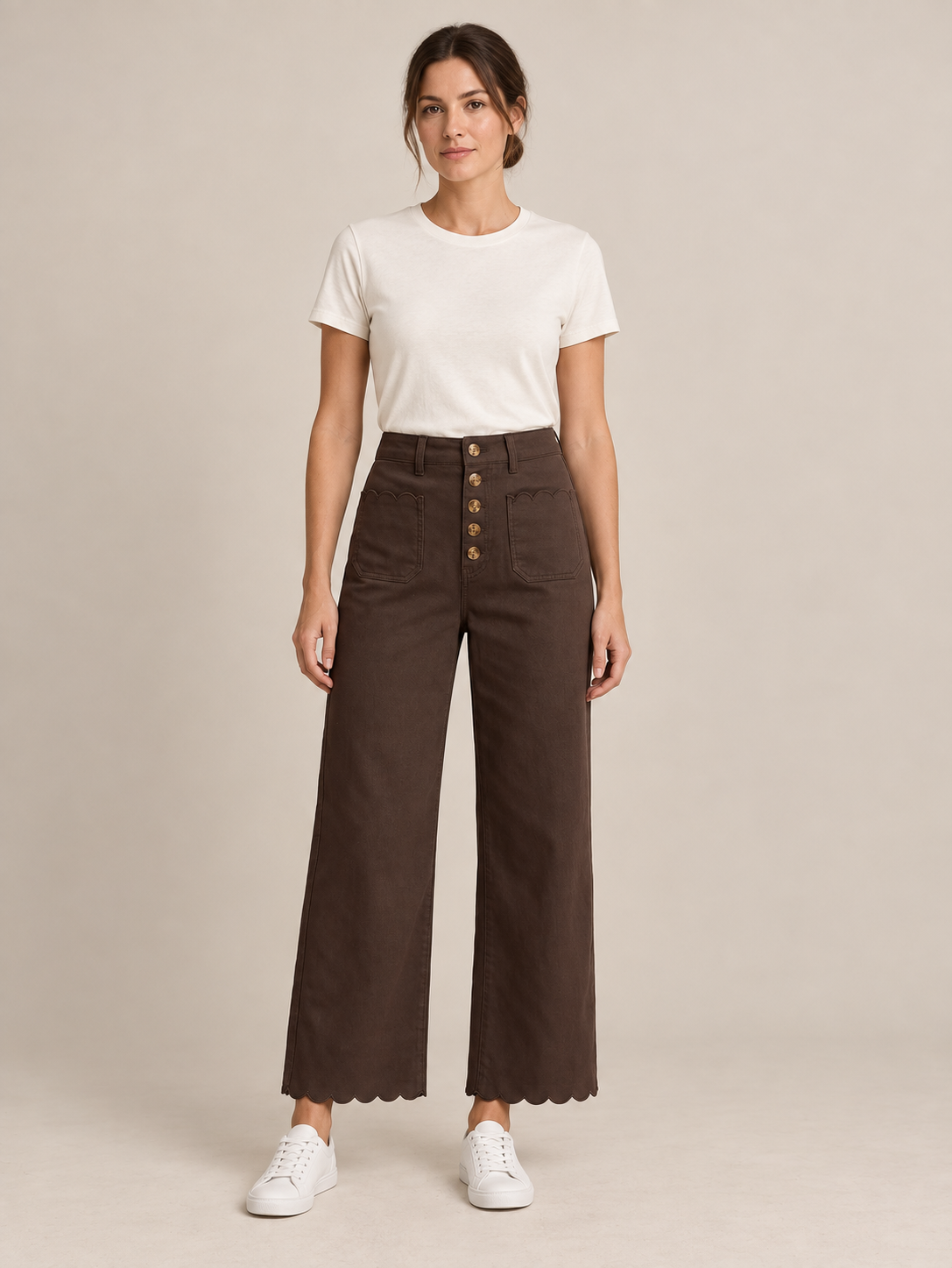 Brown scalloped-hem button-front jeans, front view on a model.