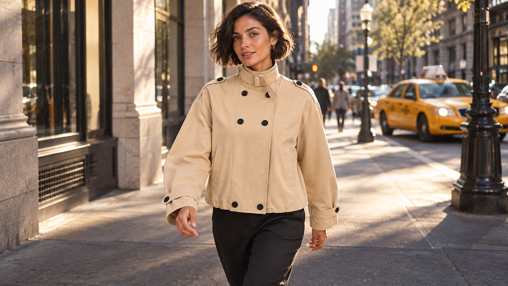 Woman wearing a camel buckle-collar jacket on a city street