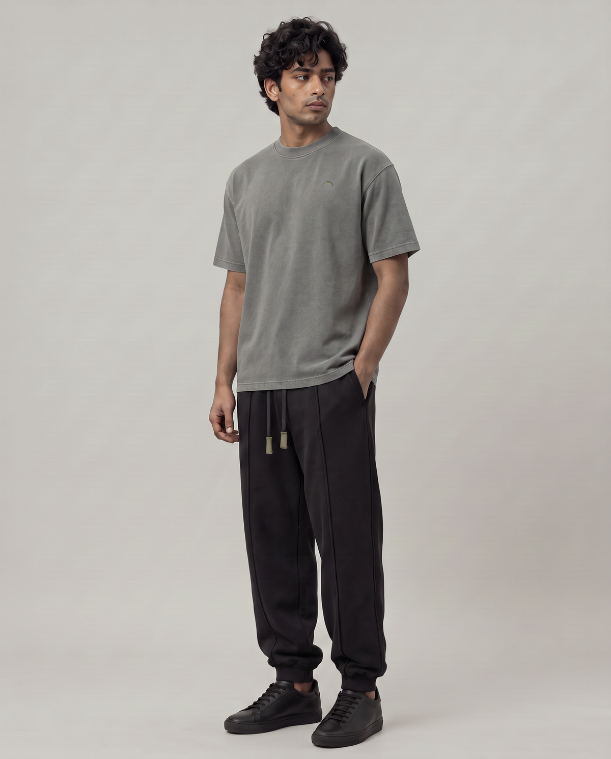 Quiet Arc T-shirt three-quarter view on model in washed graphite