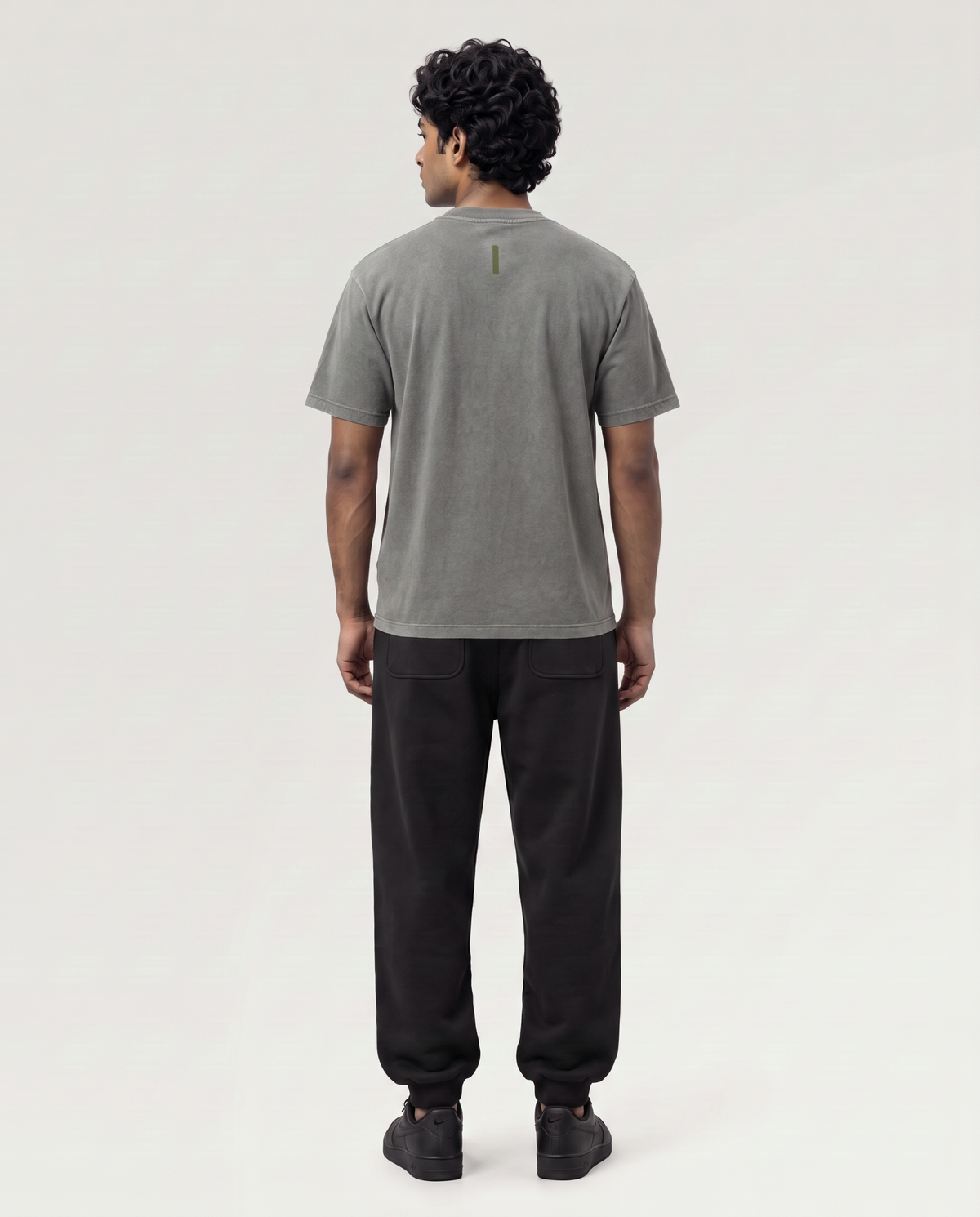 Quiet Arc T-shirt back view on model in washed graphite