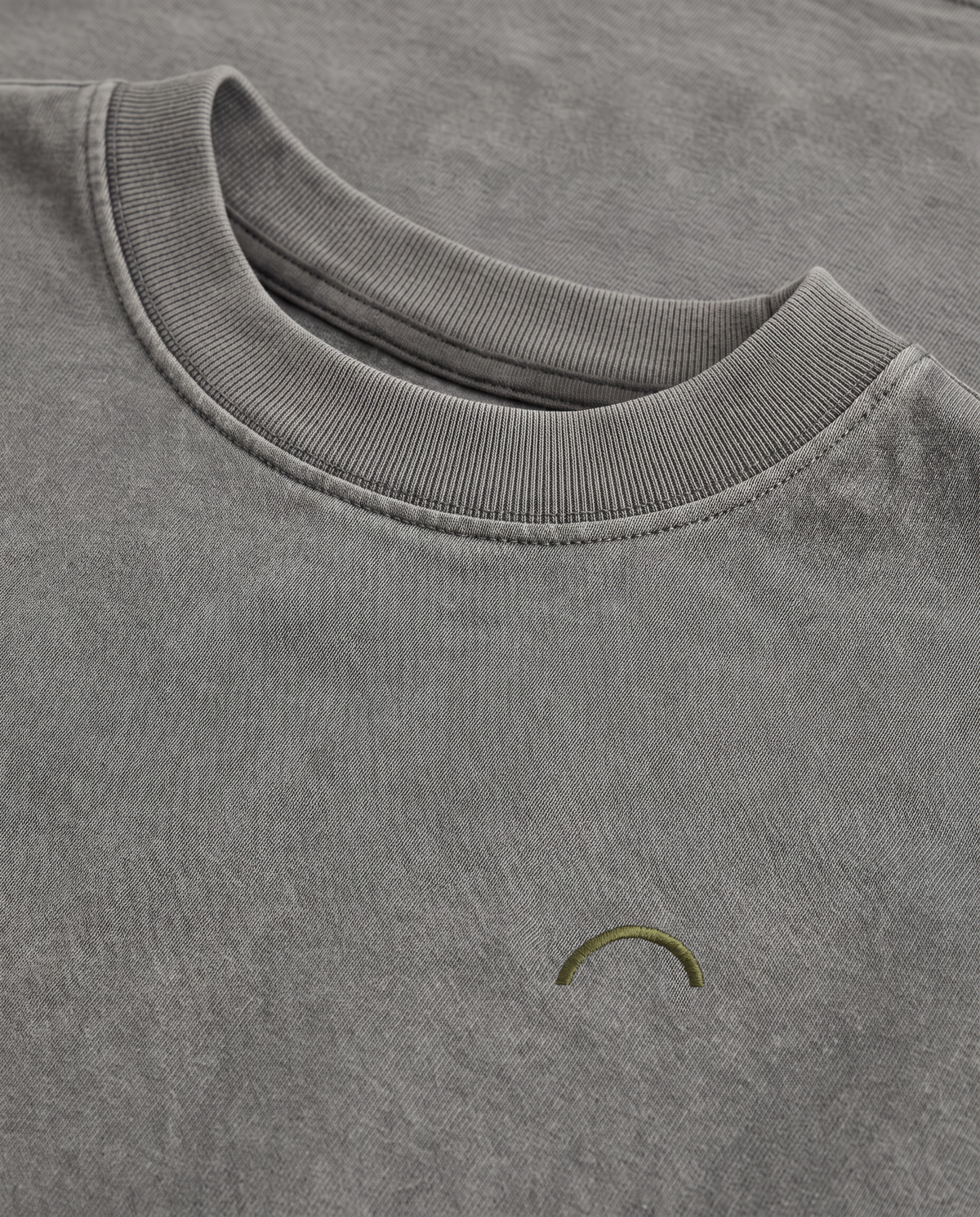 Quiet Arc T-shirt olive chest arc and double-ring collar close-up