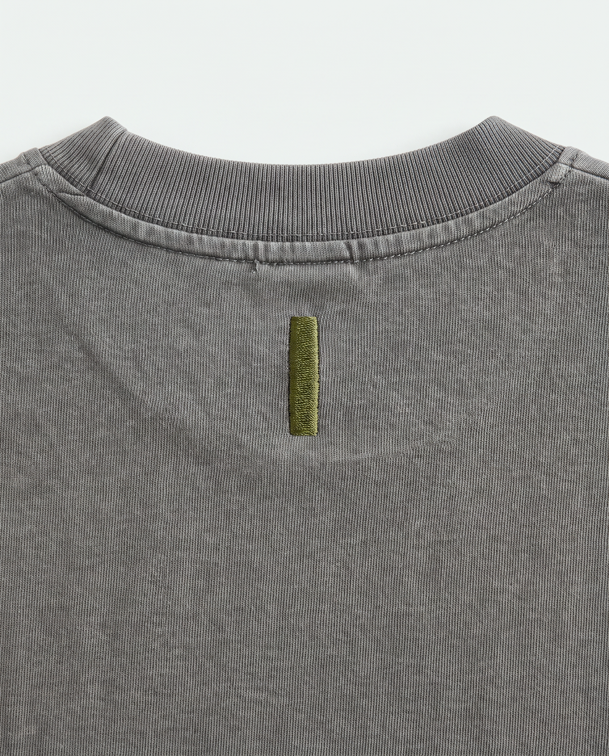 Quiet Arc T-shirt olive back-neck bar close-up