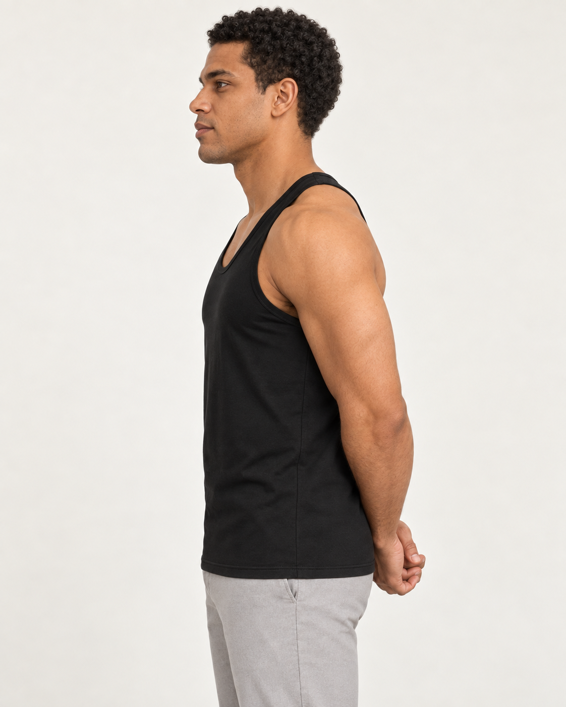 Black cotton-stretch racerback tank, on-model side view.