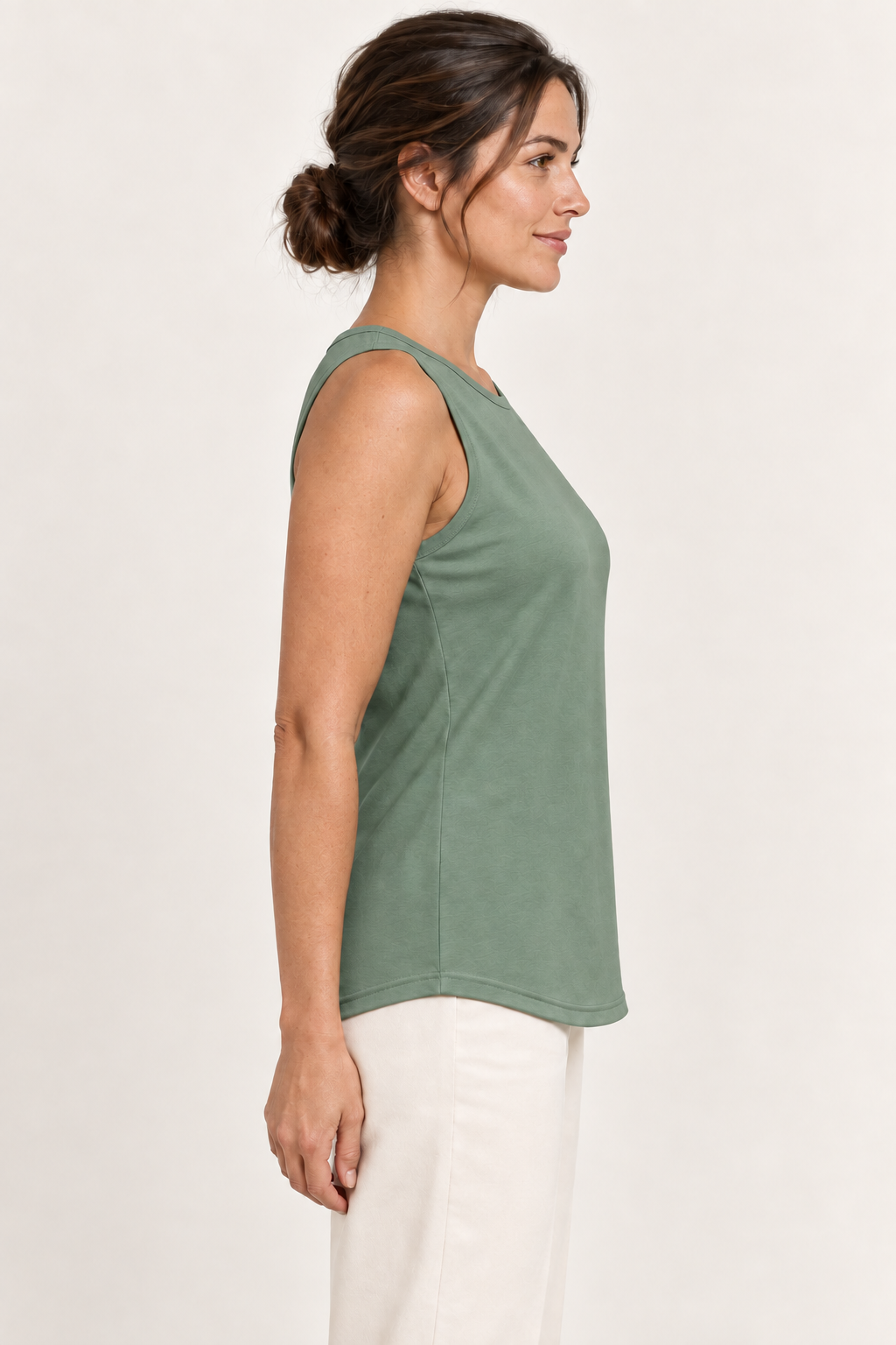 Sage green cotton-stretch round-neck tank, model side.