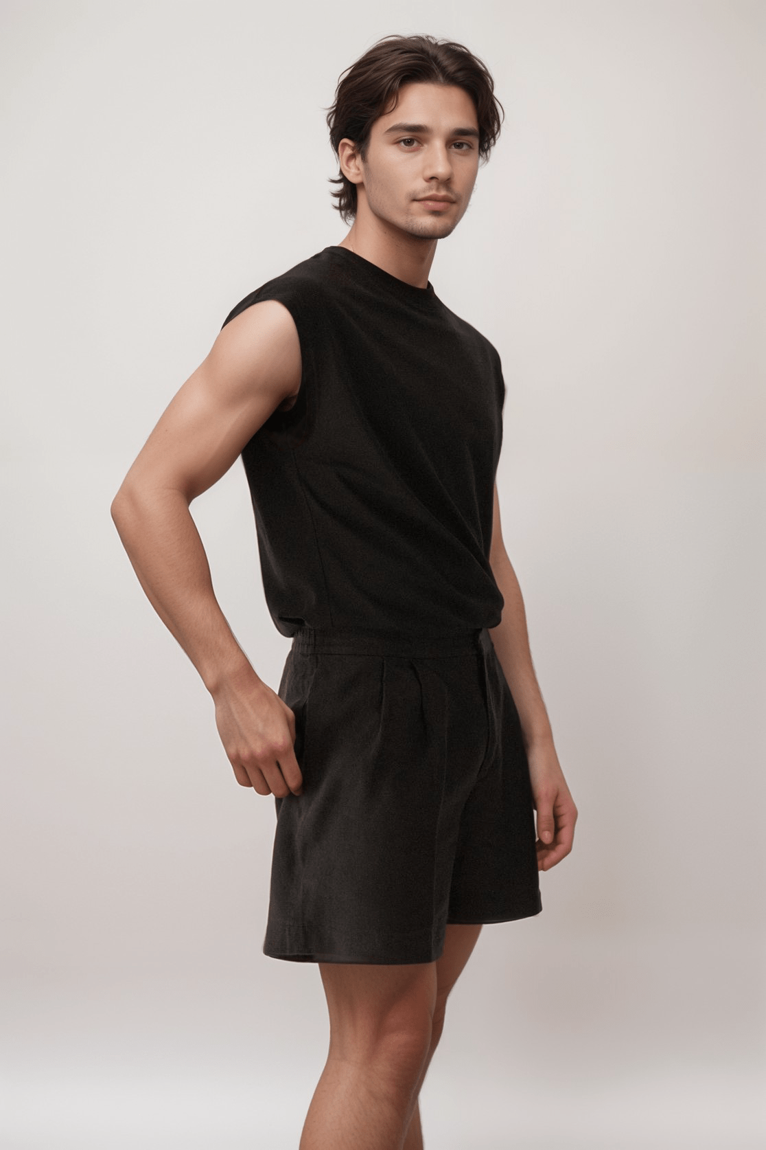 Side view of model in mens black linen shorts, highlighting lightweight material and relaxed fit for stylish summer comfort.