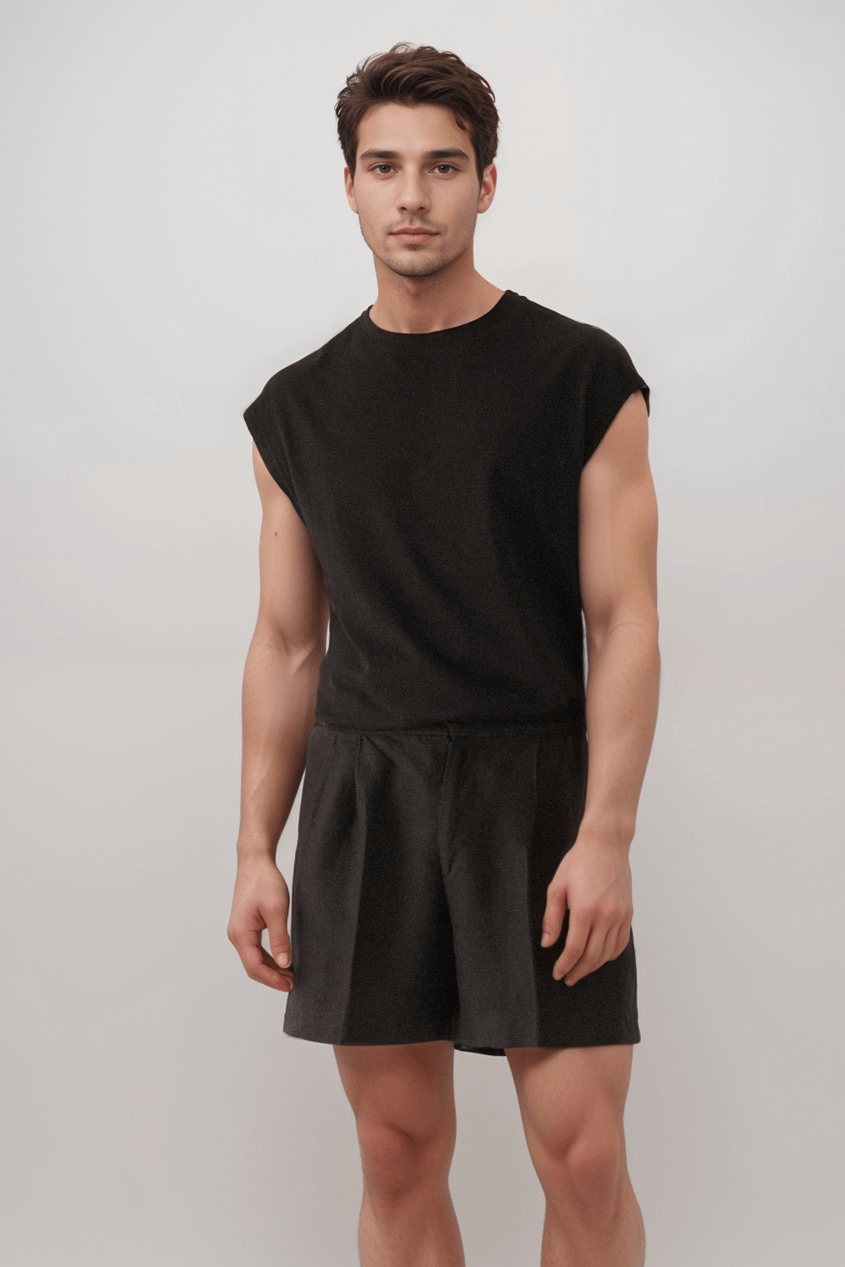 Front view of model in mens black linen shorts, emphasizing breathable linen texture and functional pleated design for everyday wear.