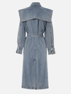 Back view of a mid-length denim trench coat showcasing a relaxed silhouette, belted waist, and wide back yoke detail.