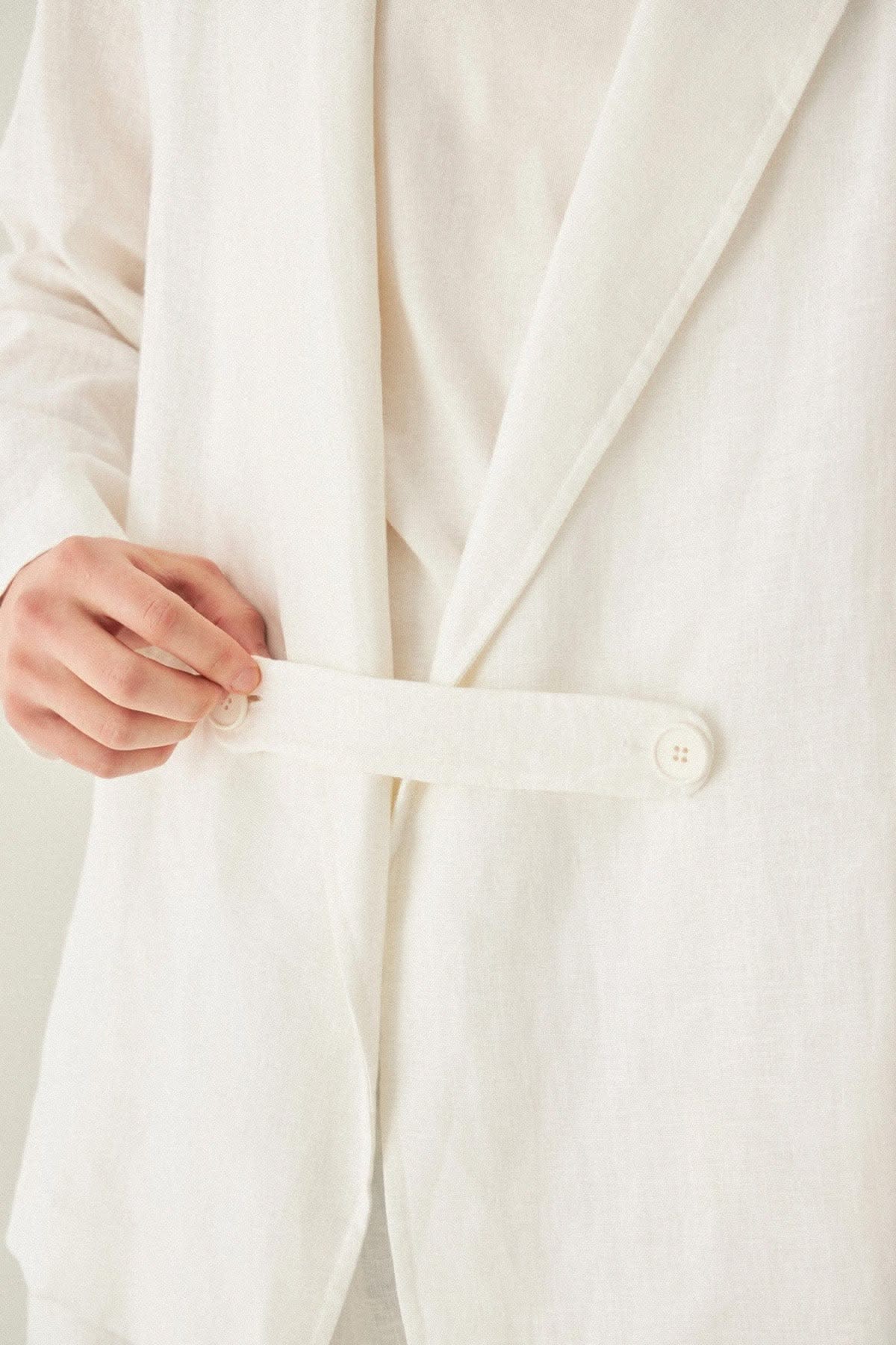 Oversized Linen Blazer in white 100% linen, lifestyle view showing product details