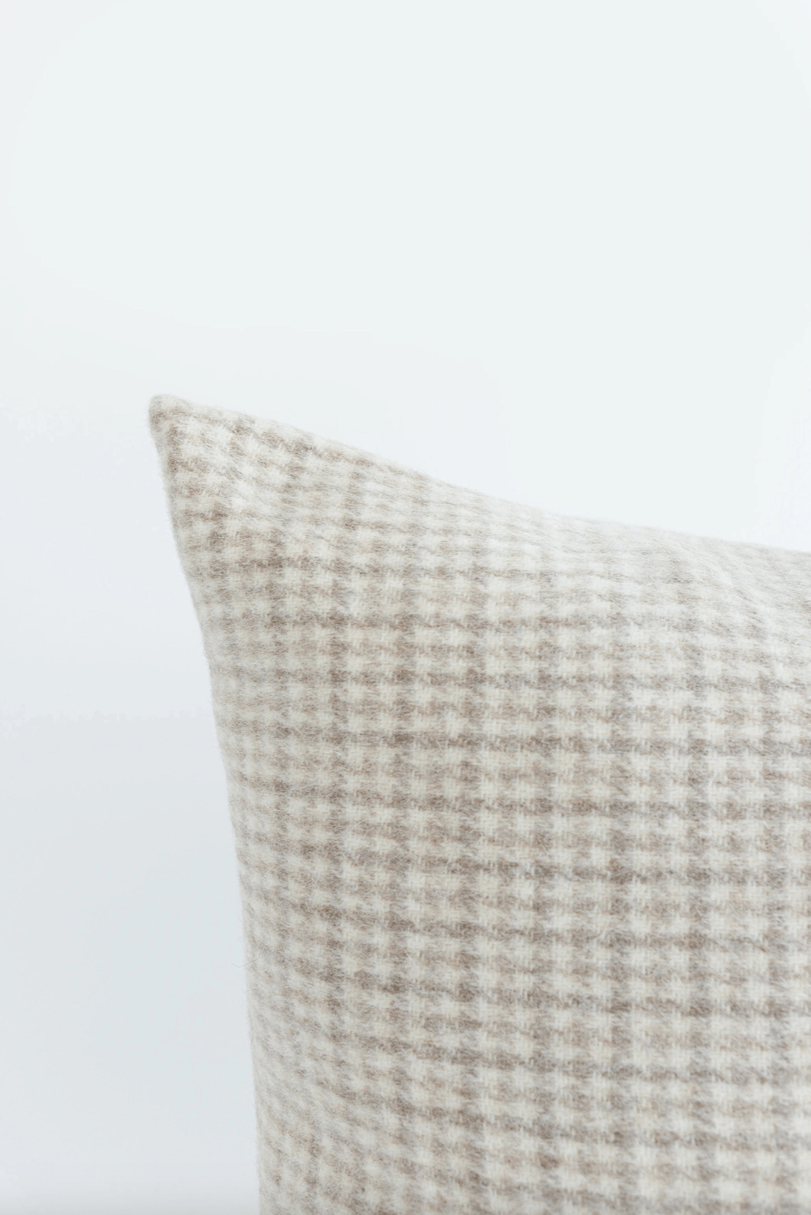 Close-up of IdyllVie Plaid Alpaca Wool Pillow Cover highlighting the soft, textured wool blend in beige and cream hues.