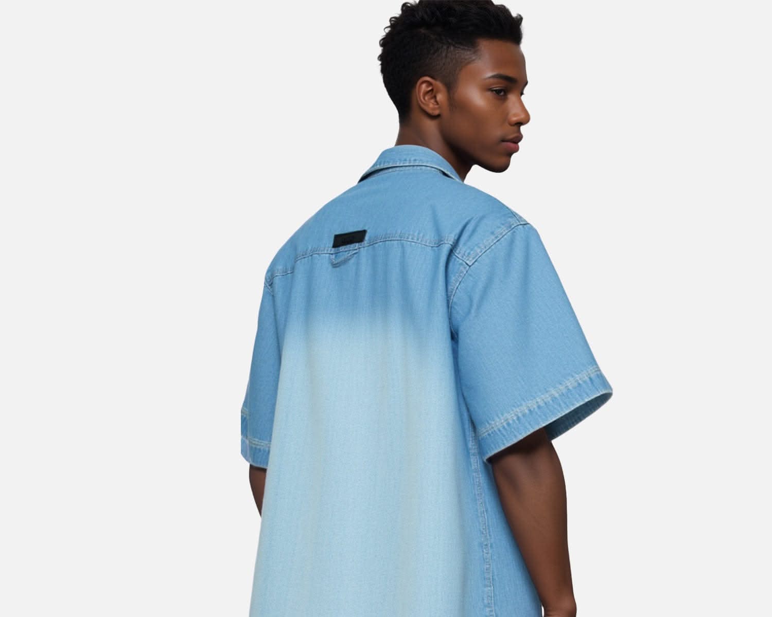 Side-back view of IdyllVie Denim Shirt showcasing short sleeves, gradient wash, and rear label accent for a unique streetwear look.