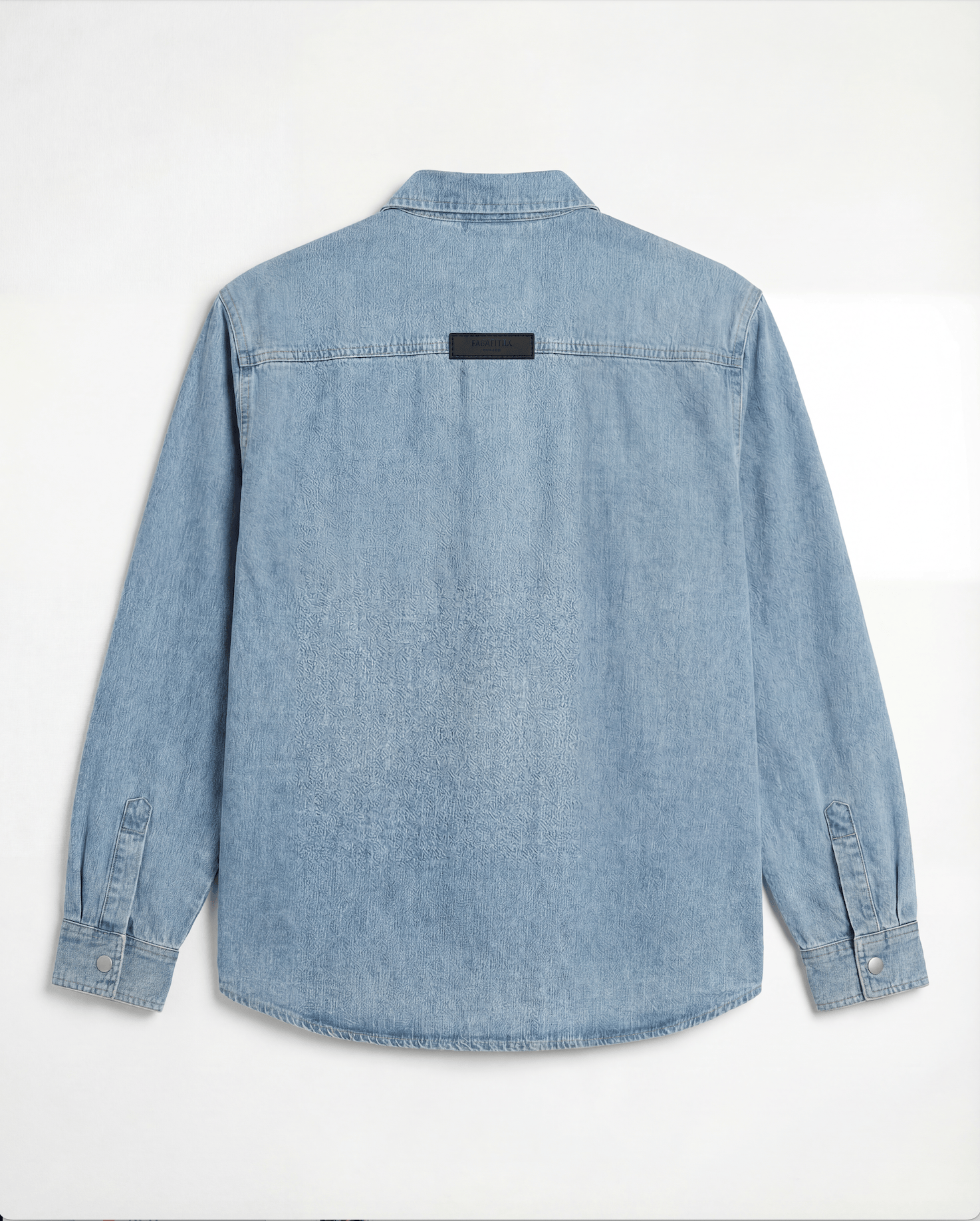 Back view of light blue denim overshirt with black label on yoke