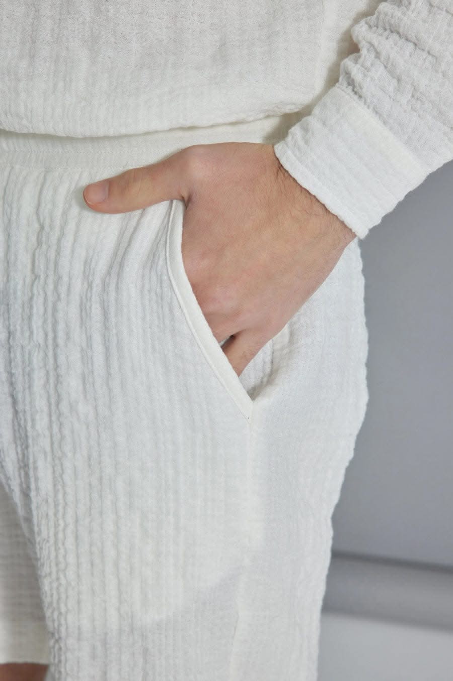 The Porterville Shorts in white 100% cotton muslin, lifestyle view showing drawstring waist, front pockets, cotton muslin texture