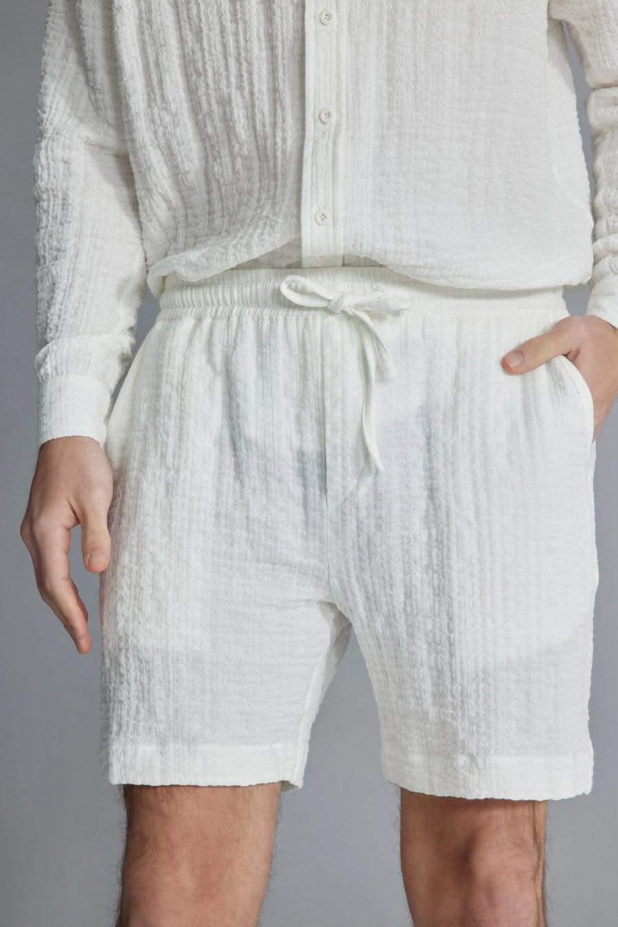 The Porterville Shorts in white 100% cotton muslin, lifestyle view showing drawstring waist, front pockets, cotton muslin texture