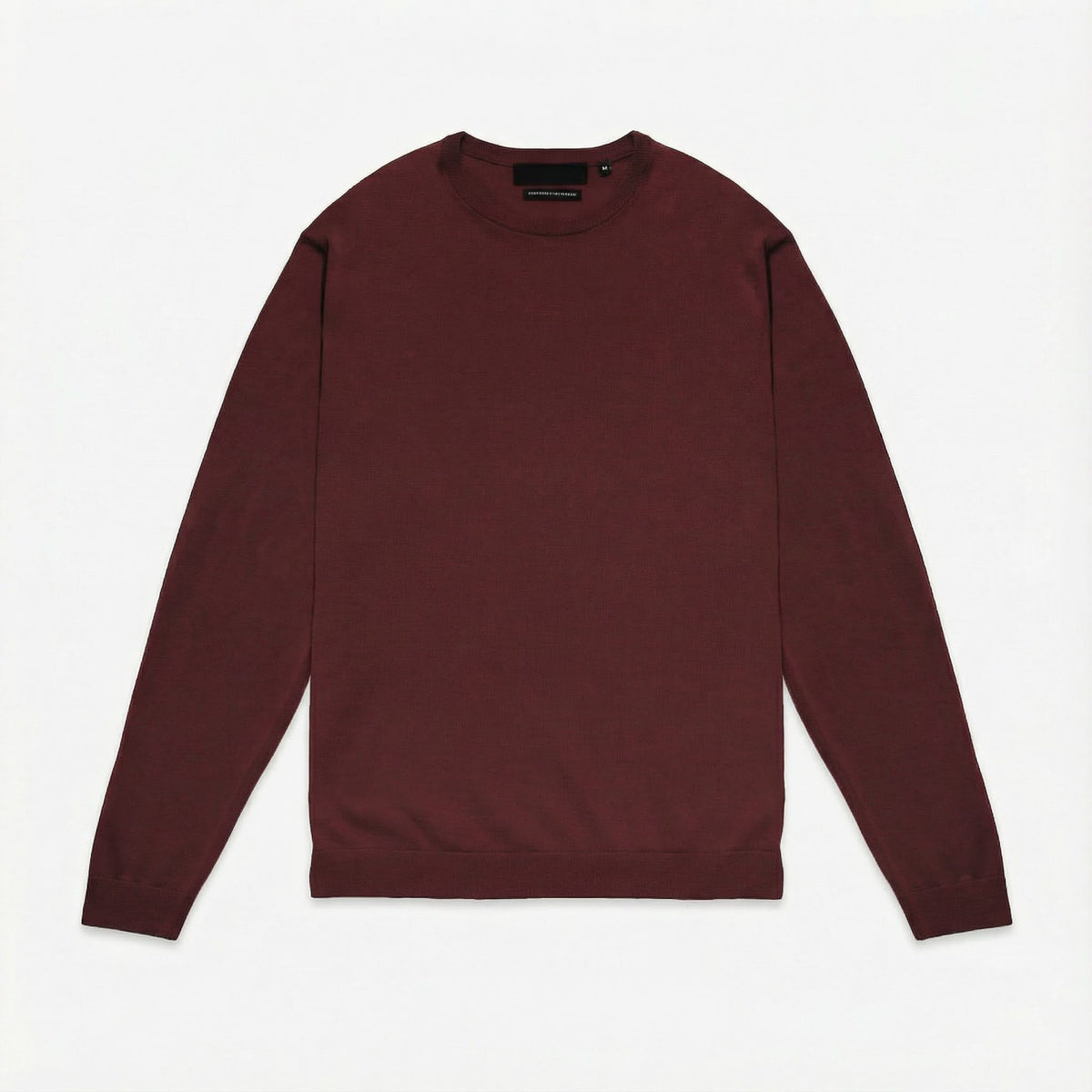 Merino Wool Crew Neck Sweater in burgundy merino wool, lifestyle view showing crew neck fit and everyday styling