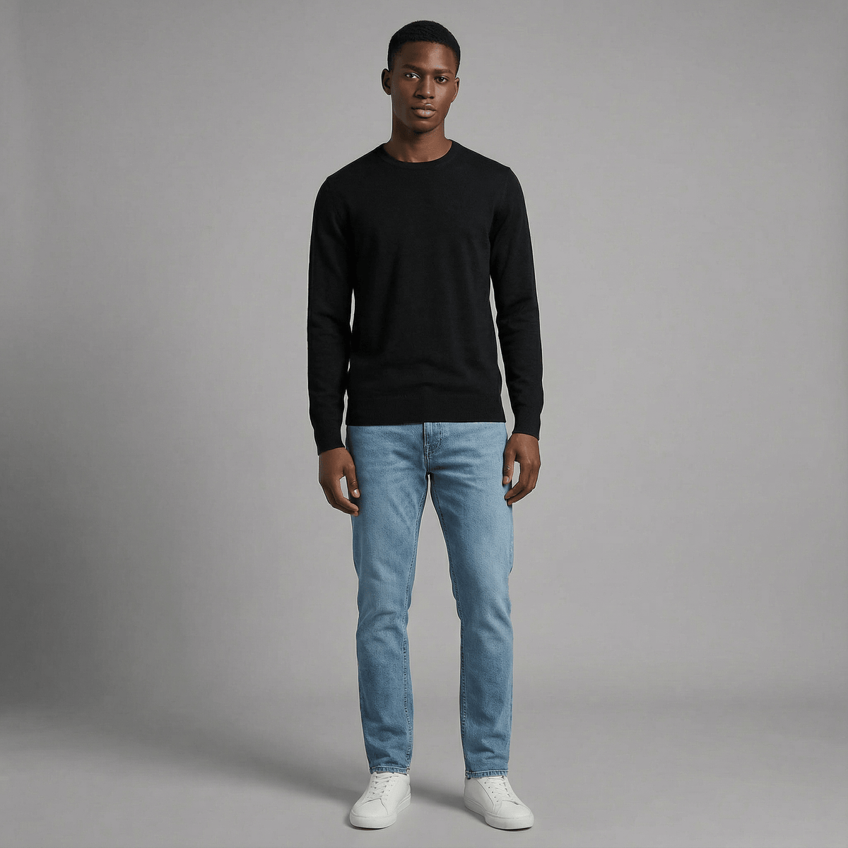 Merino Wool Crew Neck Sweater in black merino wool, angled product view showing crew neck fit and everyday styling