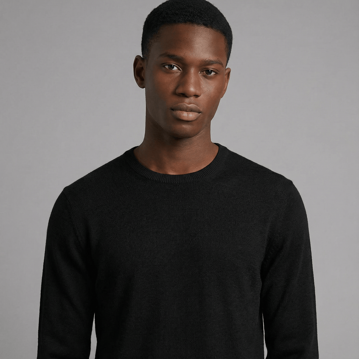 Merino Wool Crew Neck Sweater in black merino wool, detail product view showing crew neck fit and everyday styling