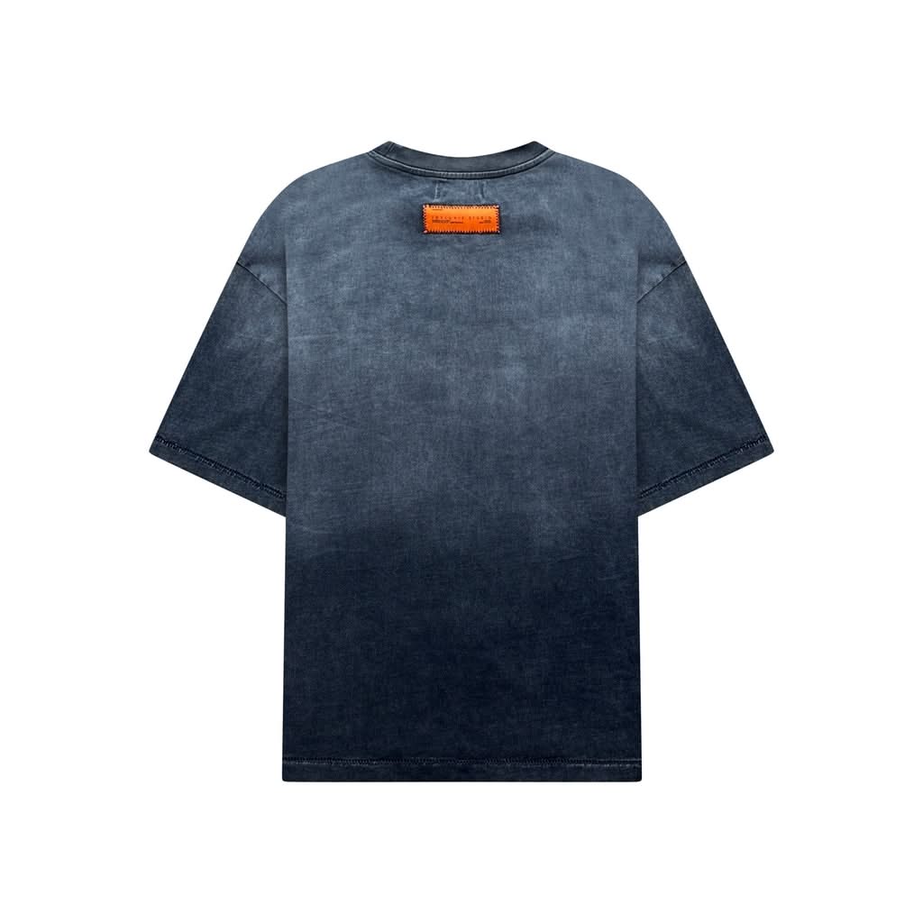 Back view of the Studio Tee - Heavyweight Cotton T-Shirt featuring a faded black wash and a bold orange IdyllVie Studio label at the neck.