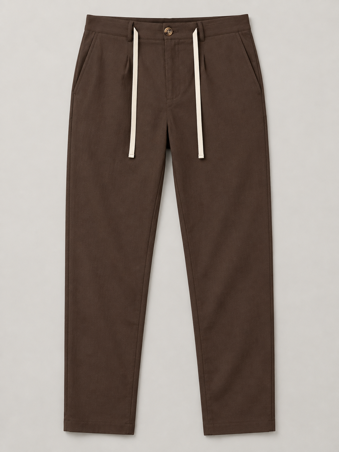 Brown drawstring trousers, flat front with button waist and side pockets.