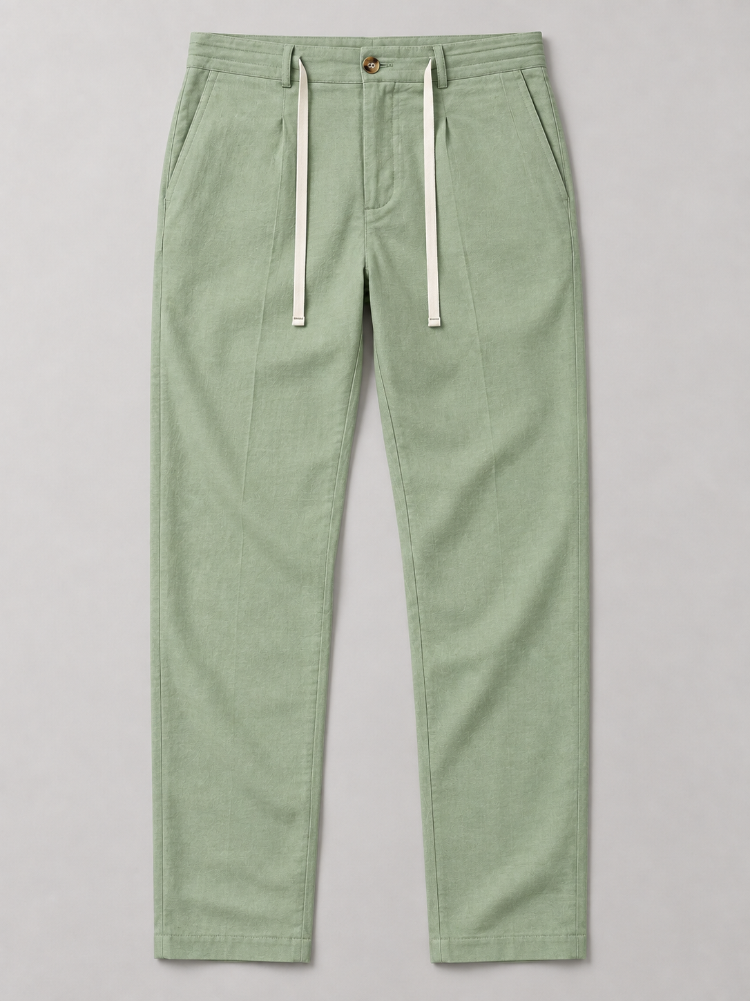 Green drawstring trousers, flat front with button waist and side pockets.