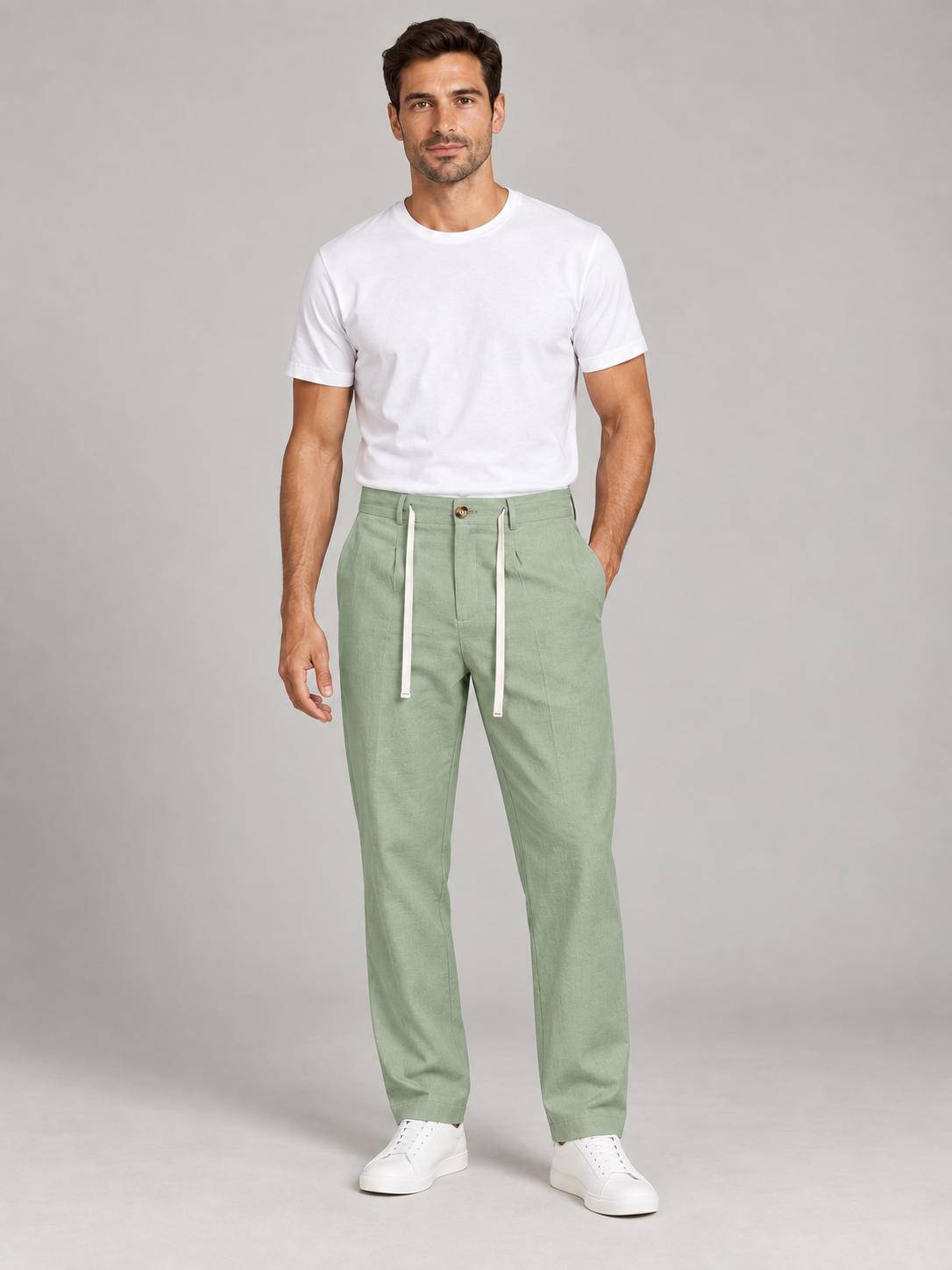 Green drawstring trousers, front view on a model.