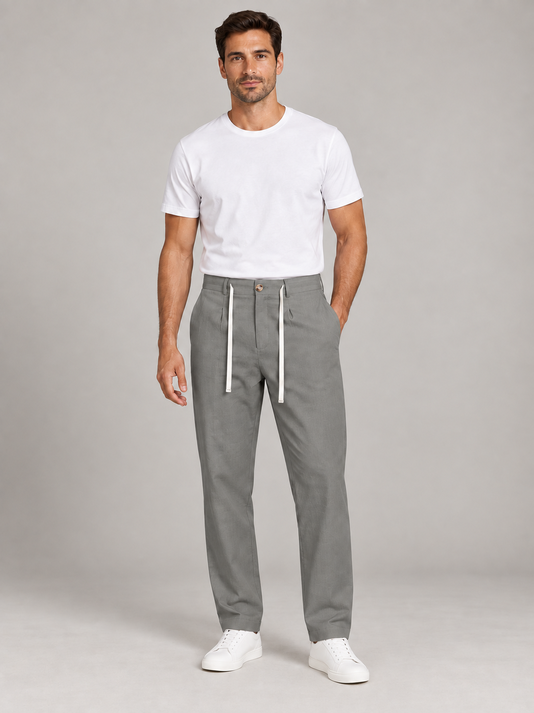 Grey drawstring trousers, front view on a model.