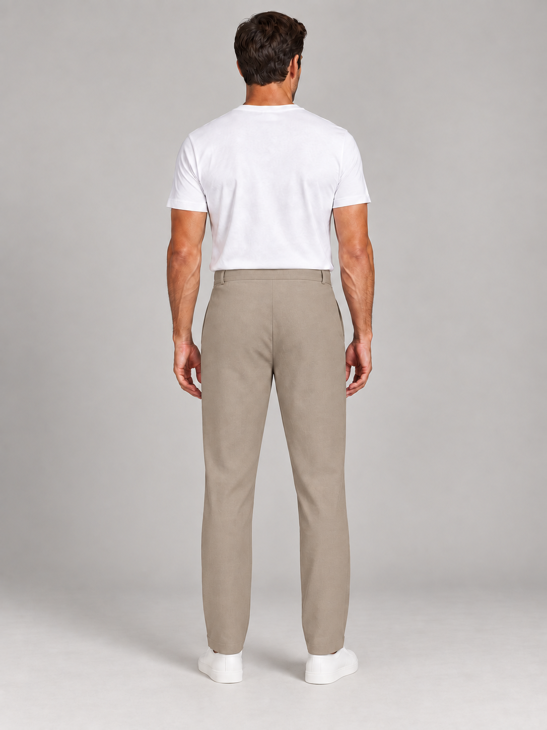 Khaki cotton button-front drawstring trousers, model back.