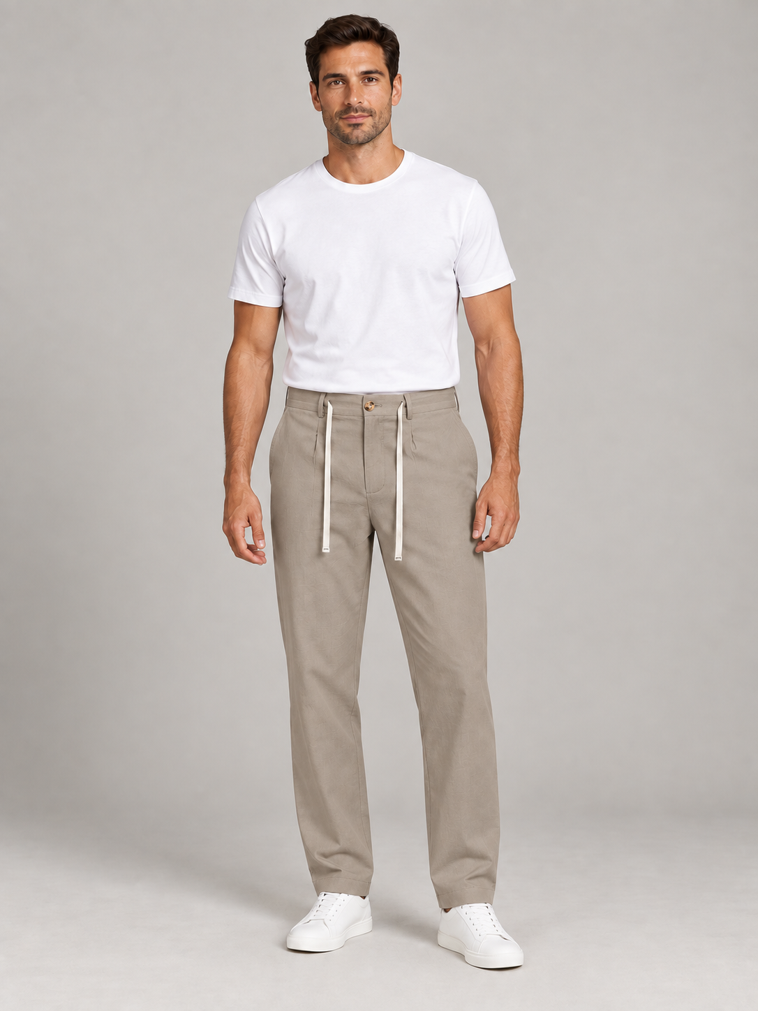 Khaki cotton button-front drawstring trousers, model front.
