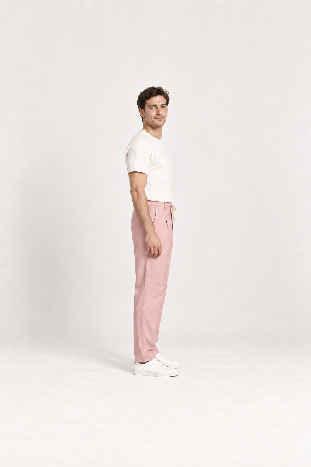 Pink cotton pleated drawstring pants, side view on an adult model.