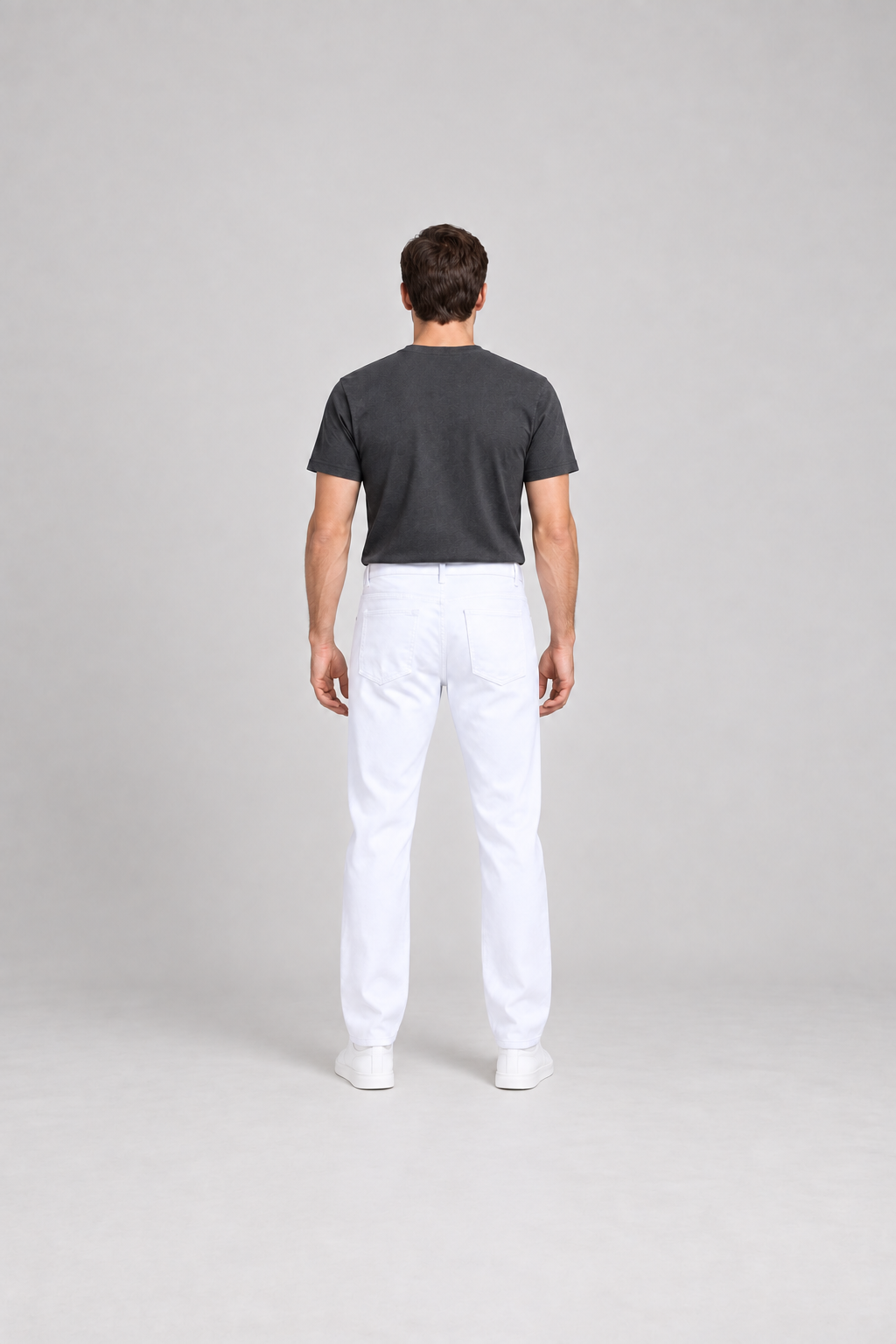 Rear view of white straight-leg jeans showing the back yoke and two patch pockets.