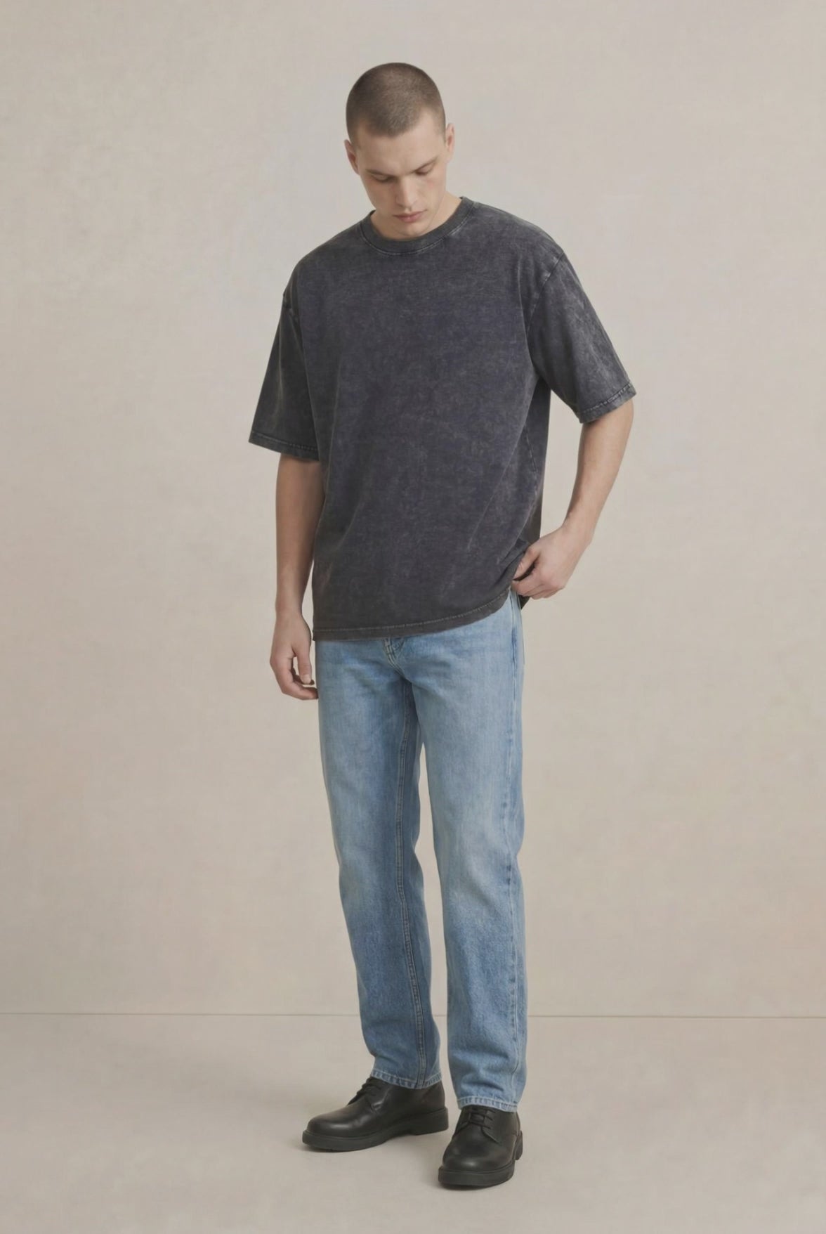 Model wearing black stonewashed T-shirt in casual style