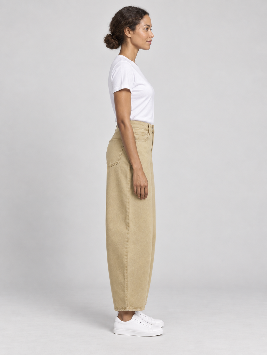 Khaki cotton barrel-leg jeans, side profile on a model.