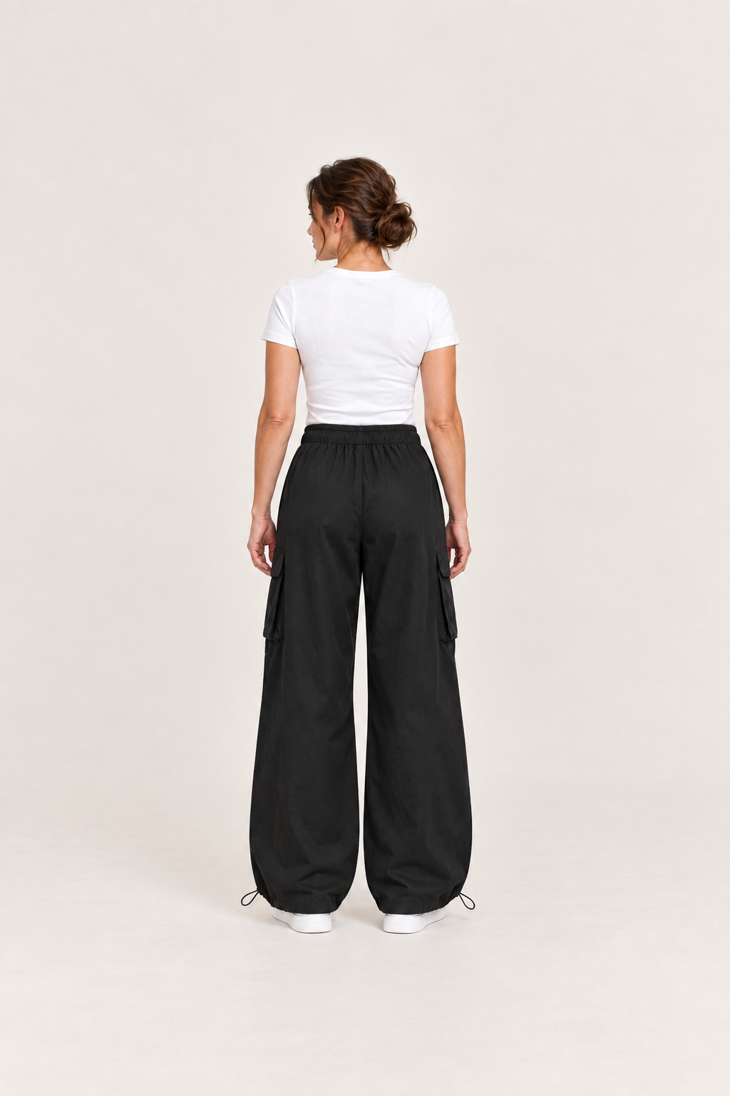 Black cotton drawstring cargo pants, back view on an adult model.