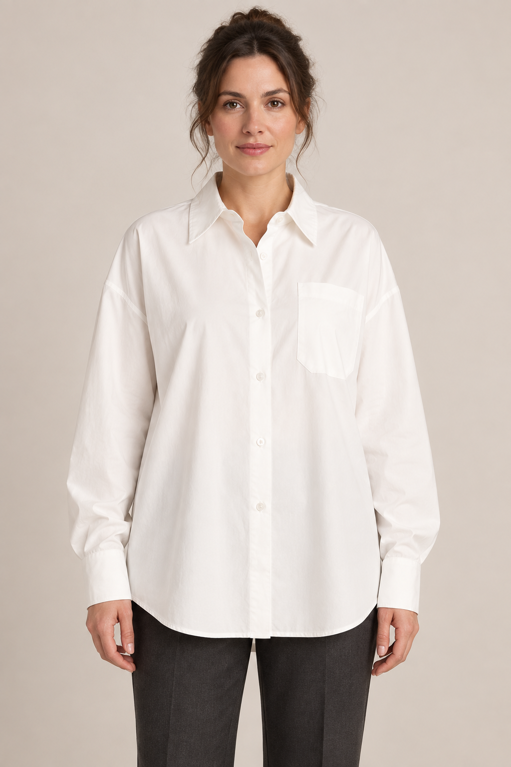 Front view of the white cotton drop-shoulder shirt with a chest pocket on a model.